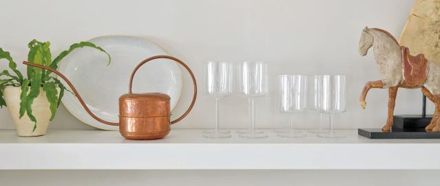 Copper watering can on shelf