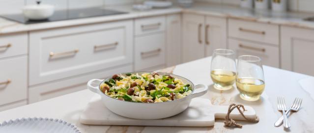 spring veggie orecchiette on counter with wine