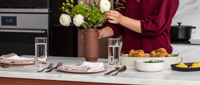 Adjusting Flowers on a Thanksgiving Table Set for Two in Touch of Modern Kitchen