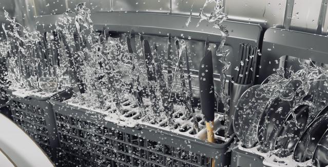 Silverware in utensil rack being washed in dishwasher